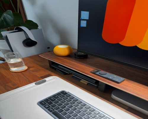 Glass of water with a slice of lemon on a wooden office desk
